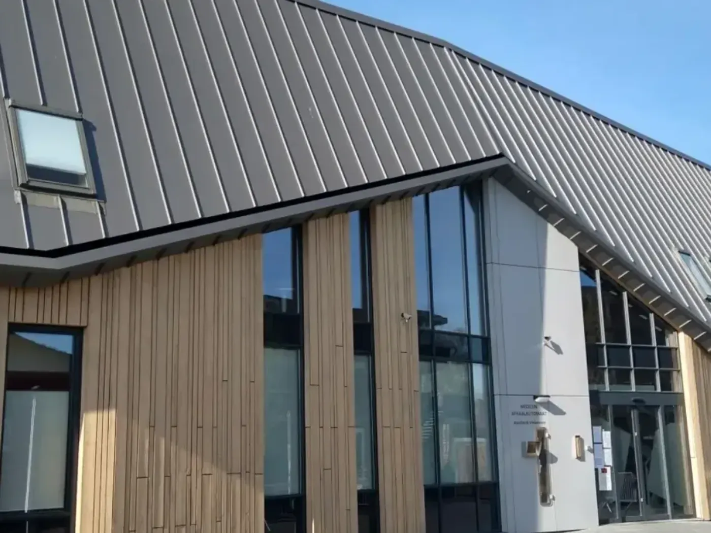 Zinklook met dakramen boven een verticale houten gevelbekleding